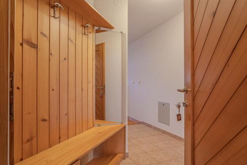 a wooden door in a room with a hallway at Oblak Estate in Rigelj pri Ortneku