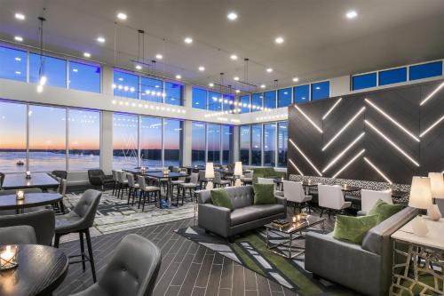 a restaurant with couches and tables and windows at Hyatt Place East Moline/Quad Cities in East Moline