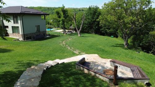 a backyard with a fire pit in the grass at Mosia Vasiloaica in Pleaşa