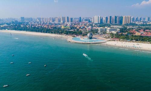 an aerial view of a beach and the ocean at Excemon Beach Hotel Beihai in Beihai