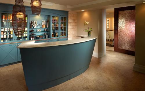 a bar in a room with blue cabinets at Omni Hilton Head Oceanfront Resort in Hilton Head Island