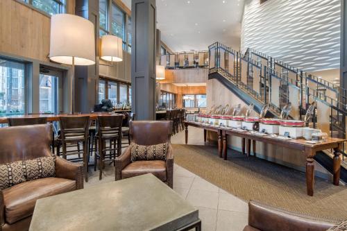a restaurant with chairs and tables and a bar at Omni Hilton Head Oceanfront Resort in Hilton Head Island