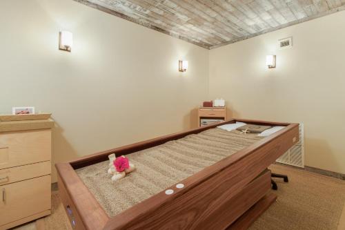 a bedroom with a bed with a teddy bear on it at Omni Hilton Head Oceanfront Resort in Hilton Head Island