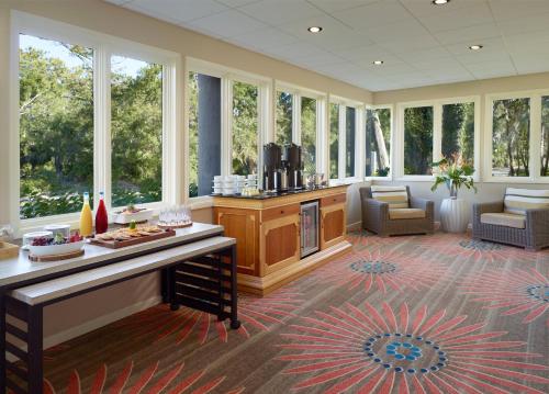 a large room with a living room with windows at Omni Hilton Head Oceanfront Resort in Hilton Head Island