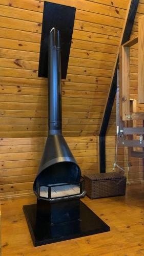 a black stove sitting on the floor in a room at Chales alto do morro 1, conforto e vista privilegiada in Rancho Queimado