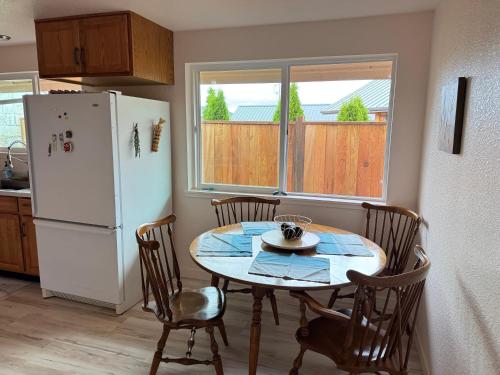 a kitchen with a table and chairs and a refrigerator at Fishermens paradise in Forks