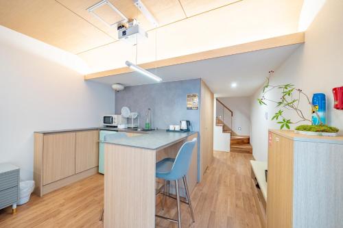 a kitchen with a counter with a blue counter top at Ocean Bliss in Ulsan