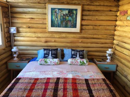 a bedroom with a bed with two night stands and two lamps at SilverCord B&B in Potrerillos