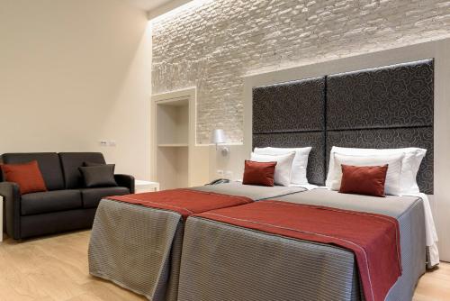 a bedroom with a large bed and a chair at Navona Luxury Guesthouse in Rome