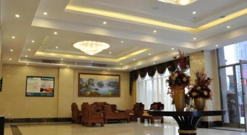 a lobby with chairs and a table in a building at GreenTree Inn Shanghai Jiading Newtown MaLu Subway Station Business Hotel in Jiading