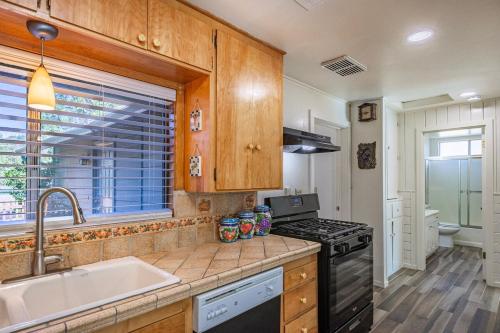 een keuken met een spoelbak en een fornuis bij Cozy Cabin by Bass Lake, with Boat Slip in Bass Lake