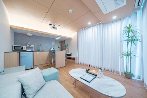 a living room with a couch and a table at Ocean Bliss in Ulsan