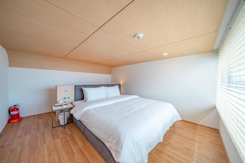 a bedroom with a large bed in a room at Ocean Bliss in Ulsan