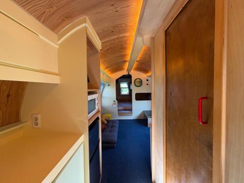 a tiny house with a hallway and a living room at Imjingotaek Hanok Stay Jeju Traditional House LP Cozy House, Wagon stay at Imjingotaek in Jeju