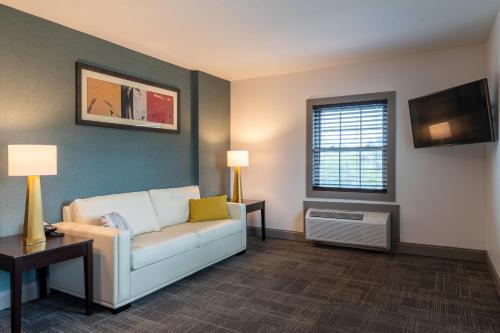 a living room with a couch and a tv at Comfort Inn Rockland - Boston in Rockland