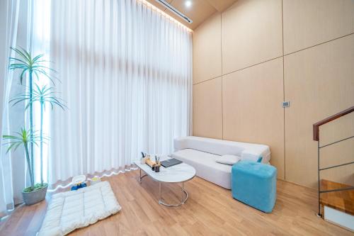 a living room with a white couch and a table at Ocean Bliss in Ulsan