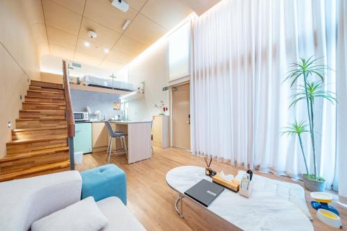 a living room with a couch and a table at Ocean Bliss in Ulsan