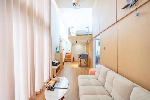 a living room with a white couch and a table at Ocean Bliss in Ulsan