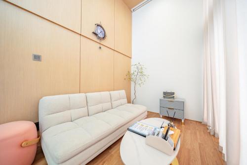 a living room with a white couch and a table at Ocean Bliss in Ulsan