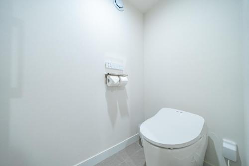 a bathroom with a white toilet in a room at Ocean Bliss in Ulsan