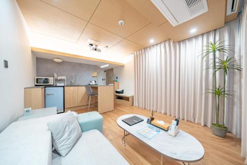a living room with a couch and a table at Ocean Bliss in Ulsan