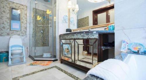 a bathroom with a fireplace and a shower and a sink at Fortune International Hotel in Xiawutun