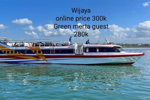 a red and white boat in the water at Green Merta in Padangbai