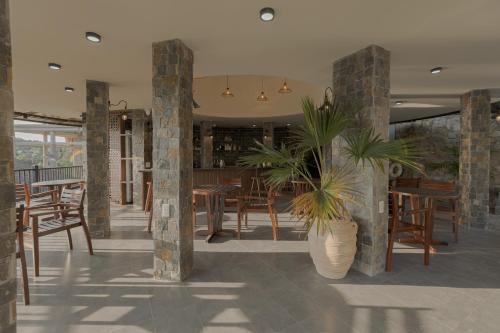 a restaurant with wooden tables and chairs and plants at Valley De Mango Hue in Thôn Châu Chữ