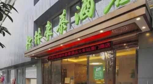a store with a sign on the front of it at GreenTree Inn Shanghai Railway Station Macao Road in Shanghai