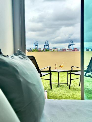 a table and chairs with a view of the ocean at Radisson Colon 2,000 Hotel & Casino in Colón