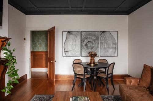 a dining room with a table and chairs at Cable's Landing, stunning heritage home near the Cataract Gorge and CBD in Royal Park