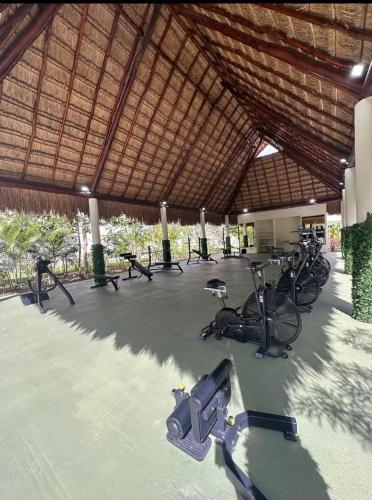 a gym with a bunch of bikes in a building at Nare bokova in Tulum