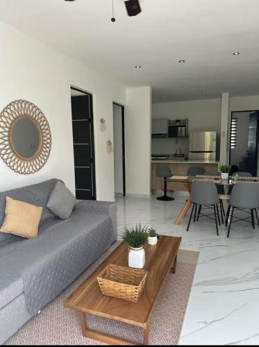 a living room with a couch and a table at Nare bokova in Tulum