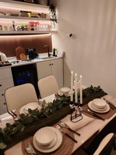 a dining room table with plates and candles on it at غرفتين نوم وصاله دخول ذاتي in Quai