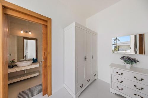 a white bathroom with a sink and a mirror at Villa Namo Chaweng 2 Bed Garden Pool in Koh Samui