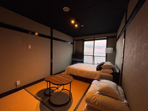 Ένα ή περισσότερα κρεβάτια σε δωμάτιο στο Alim STAY IZU アリムステイ 伊豆