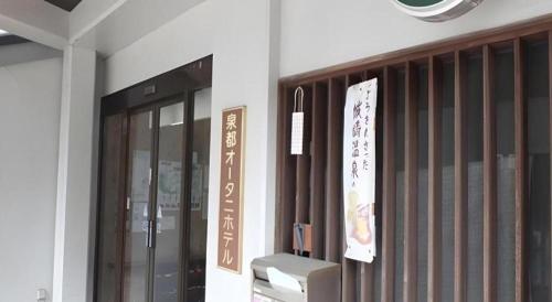 a entrance to a building with a sign on the wall at Sento Otani Hotel in Toyooka