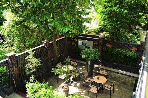 an overhead view of a patio with a table and chairs at Alp Hotel in Amsterdam