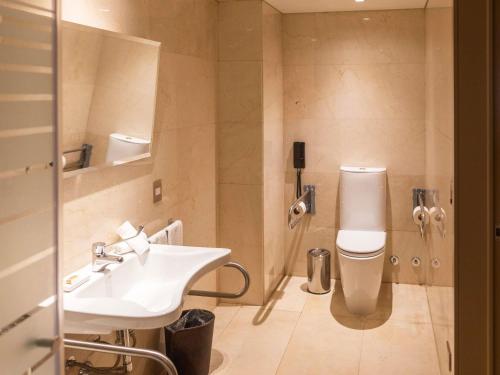 a bathroom with a sink and a toilet at Palladio Hotel Buenos Aires - MGallery Collection in Buenos Aires