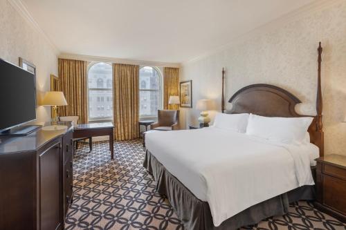 a hotel room with a large bed and a television at Omni San Francisco in San Francisco