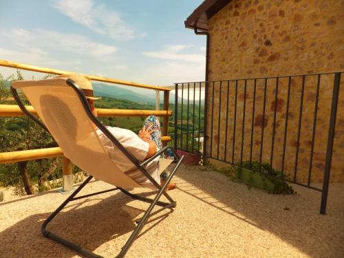 a chair sitting on top of a balcony at Pekko in Spello