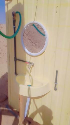 a bathroom with a sink and a mirror at مخيمات للايجار طريق الثمامه in Riyadh