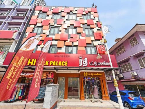 a tall building with a red and orange building at Capital O 90574 Hotel Glo in Kuala Lumpur