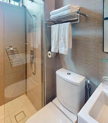 a bathroom with a shower and a toilet and a sink at S Hotel in Johor Bahru