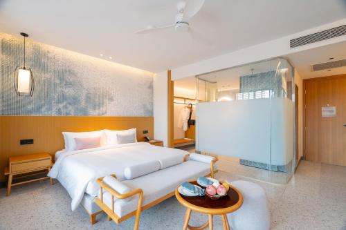a hotel room with a bed and a table at Wyndham Garden Phuket Kamala in Kamala Beach