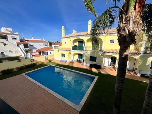 a villa with a swimming pool in front of a house at Rockfield 4 in Albufeira