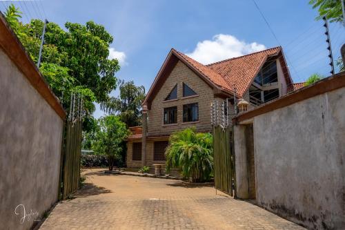 a house with a gate in front of it at Mtwapa Curtie Home in Mombasa