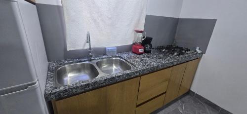 a kitchen counter with a sink and a stove at pent-house 3 planta alta in San José del Cabo