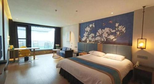 a hotel room with a bed and a large window at Magnotel Shenyang Consulate Qingnian Street in Shenyang