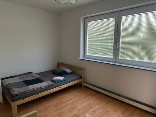 a small bedroom with a bed and a window at WG Riedau in Riedau